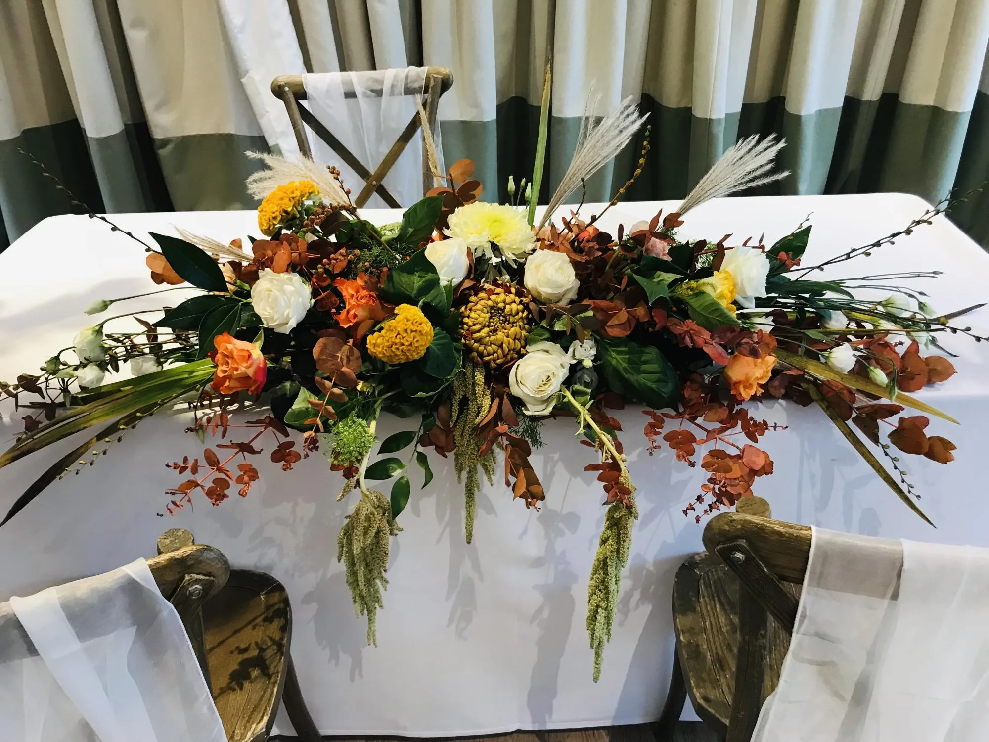 Wedding top table dressed with autumnal flowers