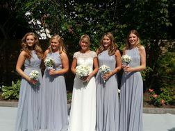 Bridesmaids in blue with white roses